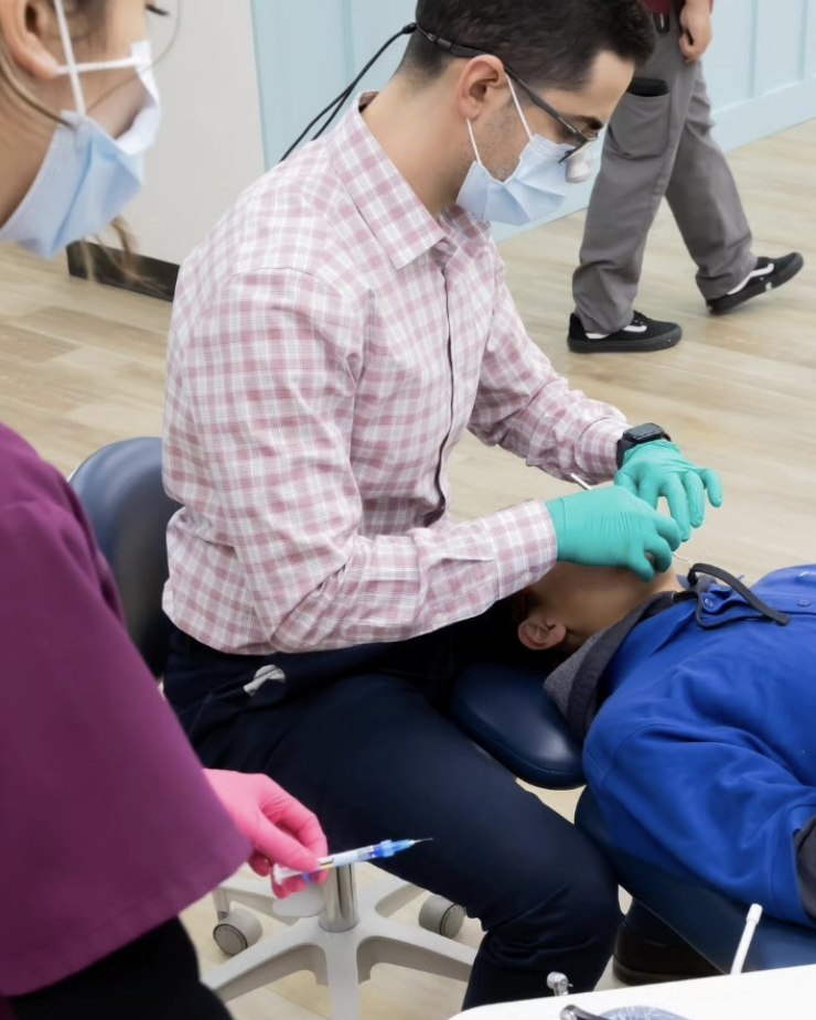 Dr. Faranesh working on a patient