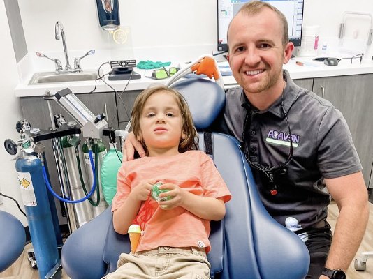 Dr. Neu with a young patient in the chair