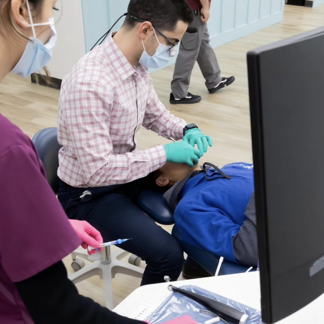 Dr. Faranesh working chairside with a patient