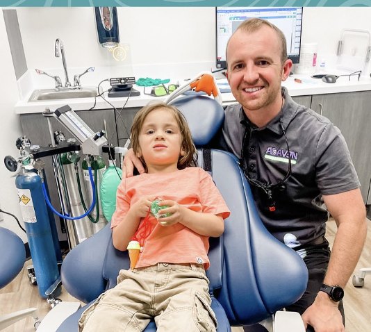 Dr. Neu with a young patient in the dental chair